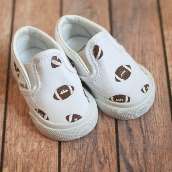 white slip on vans with footballs painted on. 