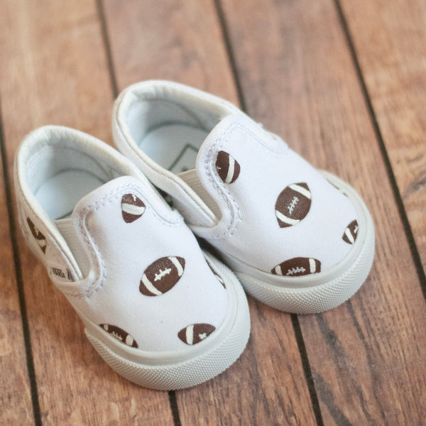 white slip on vans with footballs painted on. 