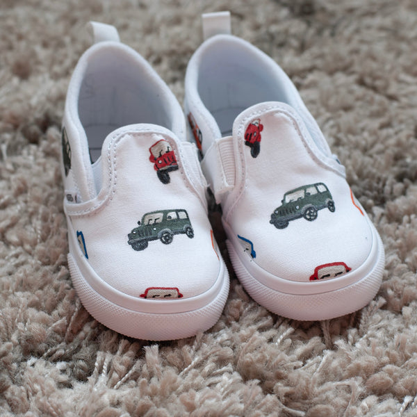 white slip on vans with cars painted on 