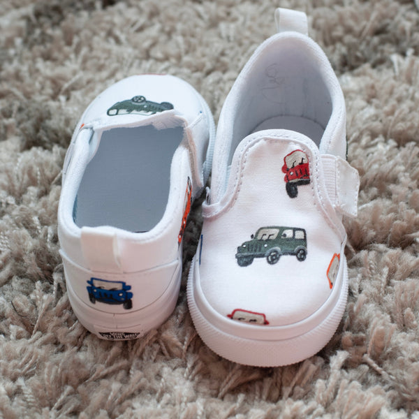 White slip on vans with cars painted on 